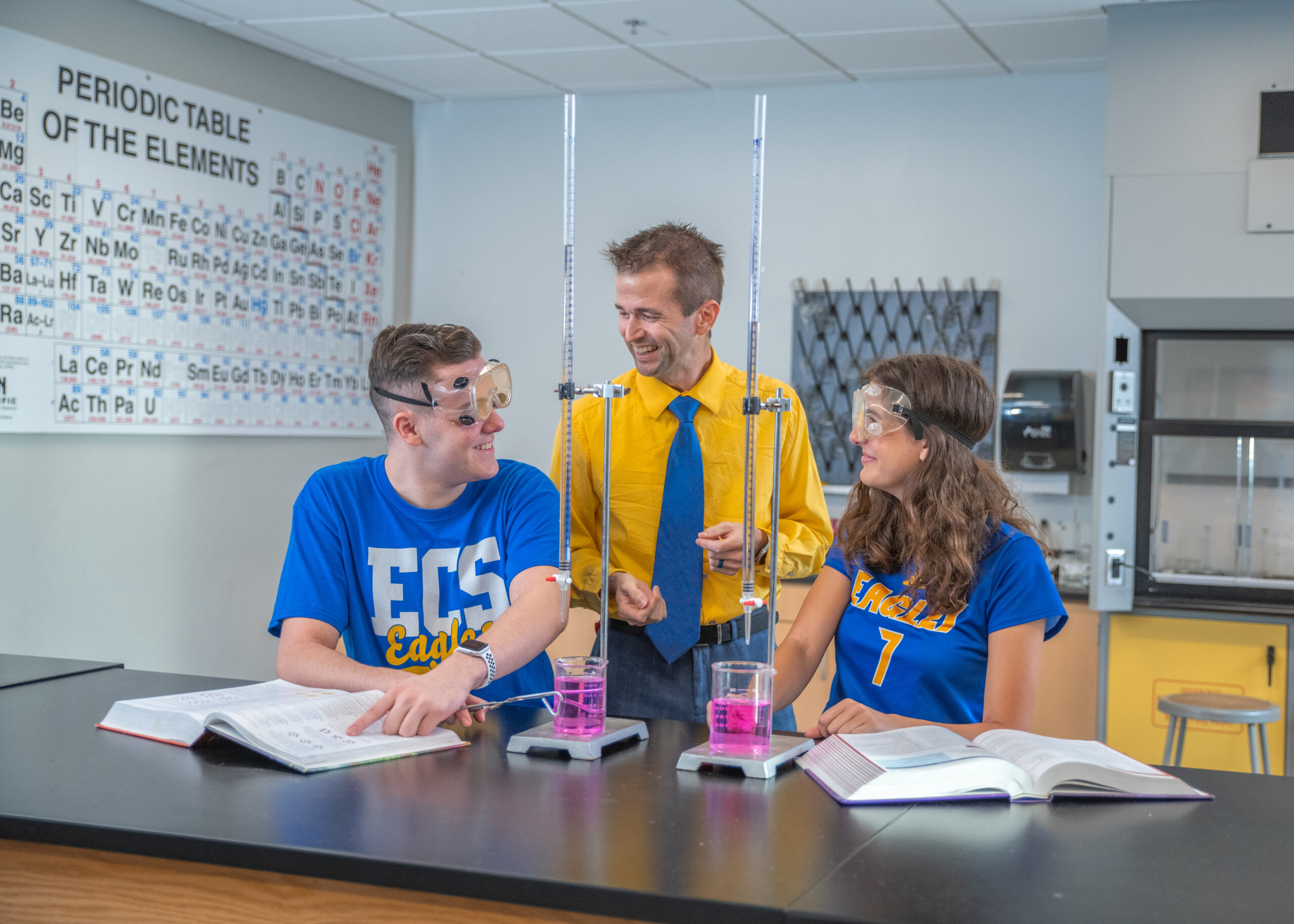 Science teacher doing a chemistry lesson with high school students